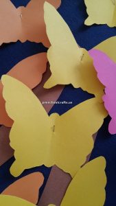 Make butterfly with colored paper for preschool
